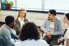 Young people sitting circle having discussion. Photo by Freepik.